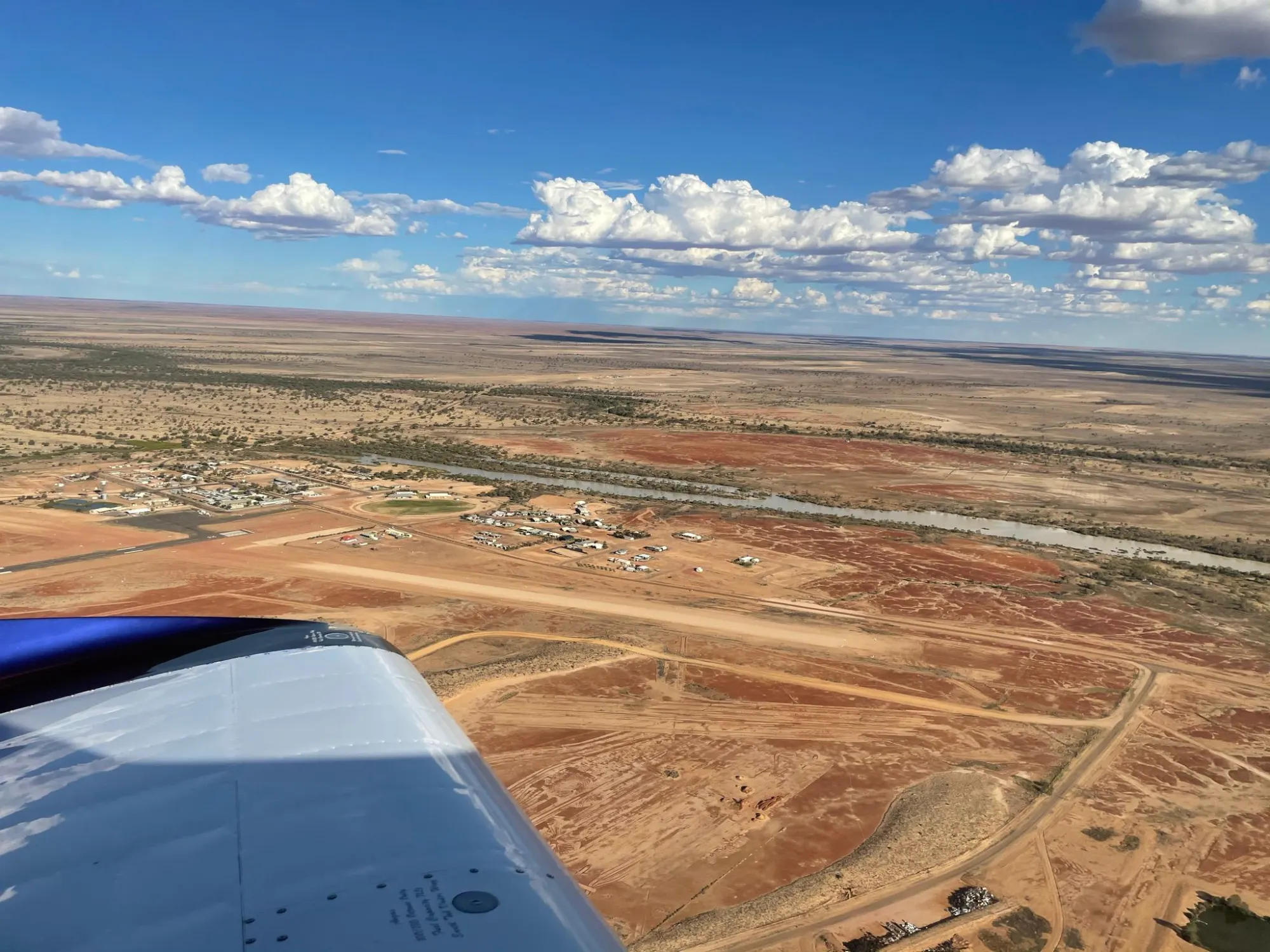 Aerial view of country Queensland through the wing of a fixed-wing