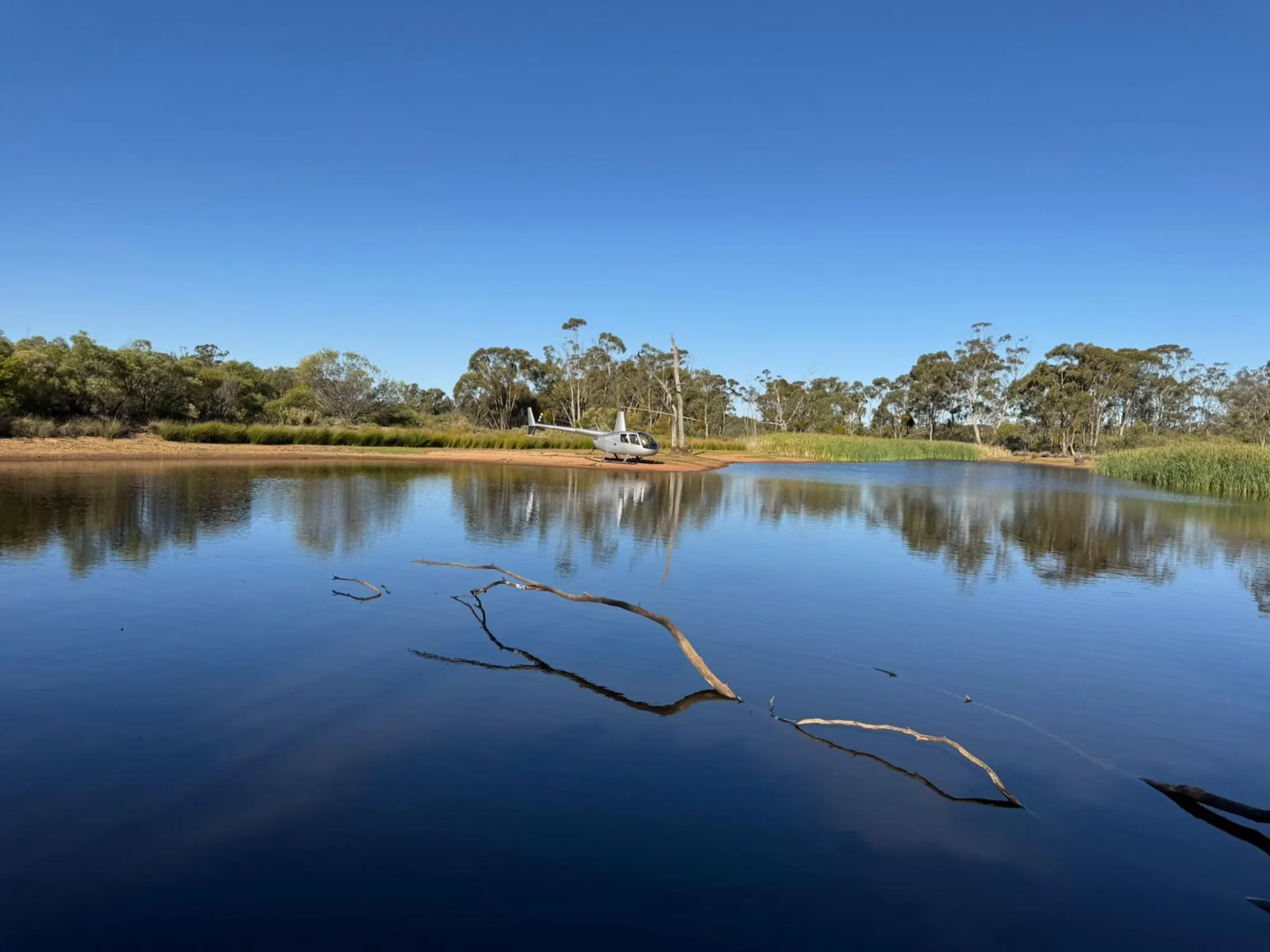 Helicopter parked beside a country lake