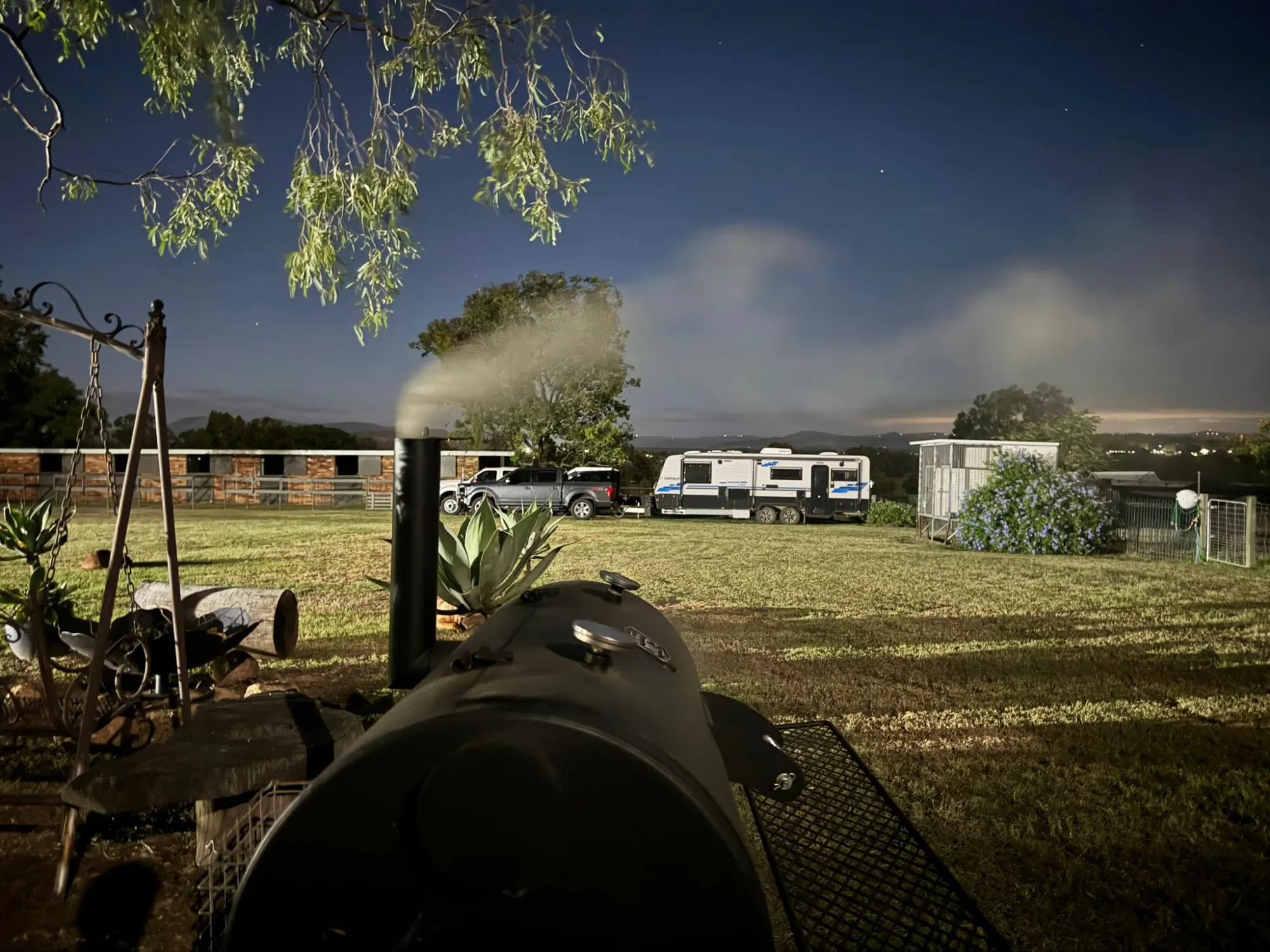 The mobile office camped under the stars with a firepit lit
