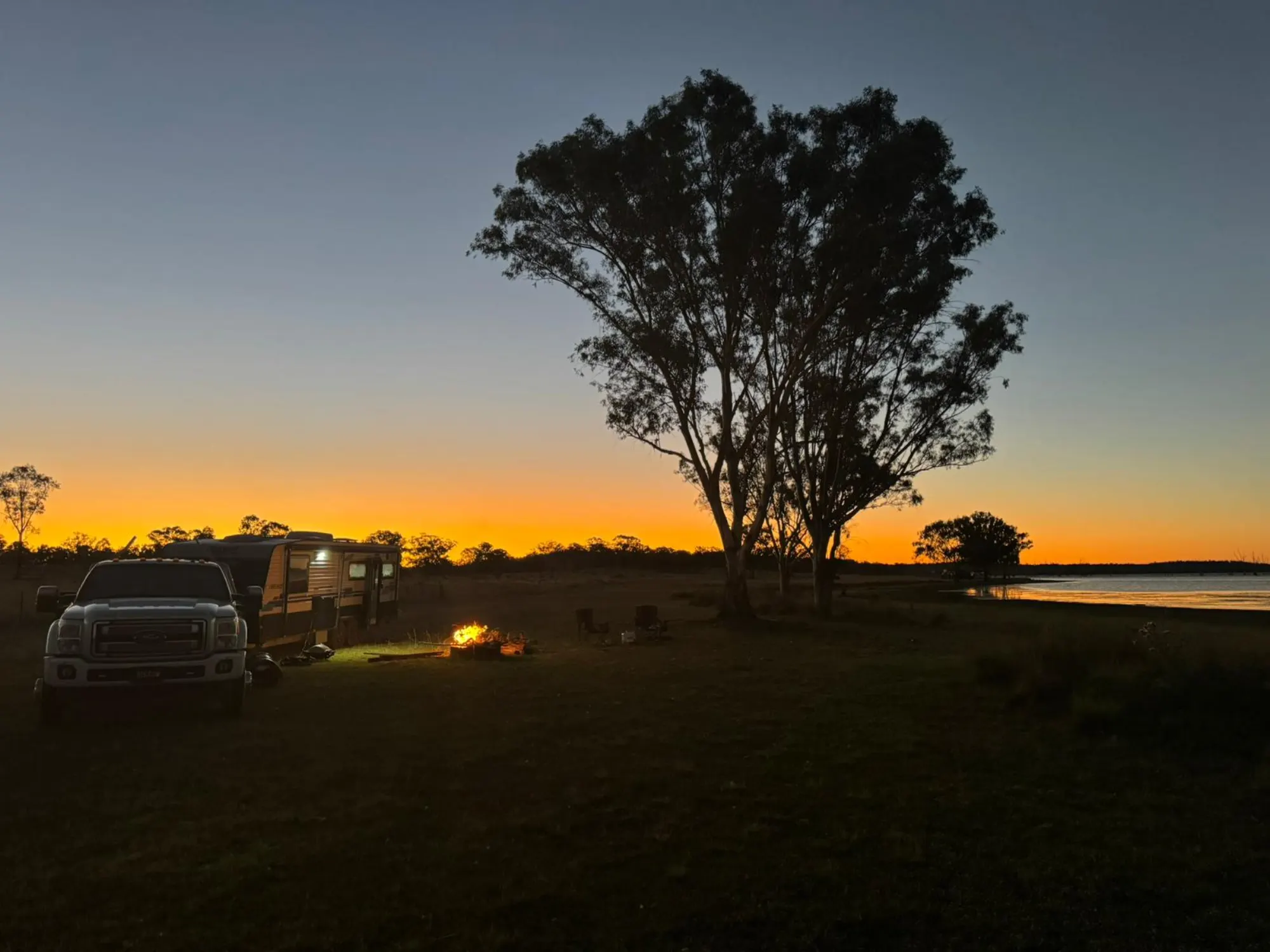 The mobile office set up at sunset, lakeside camp