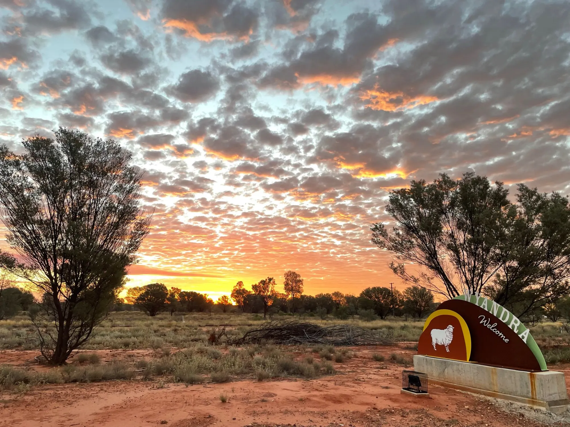 Outback town welcome sign at sunset