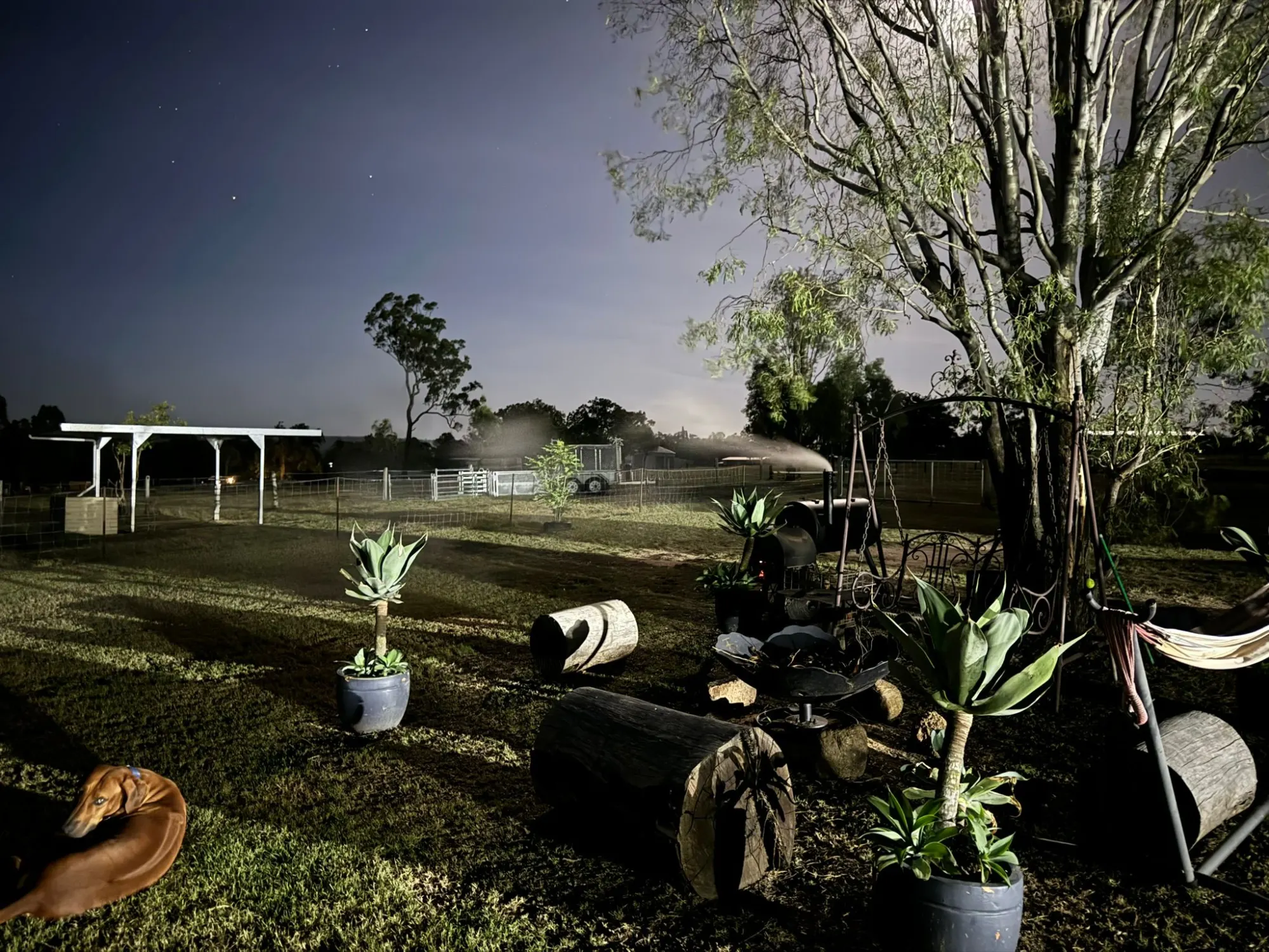 Country property floodlit under a starry sky