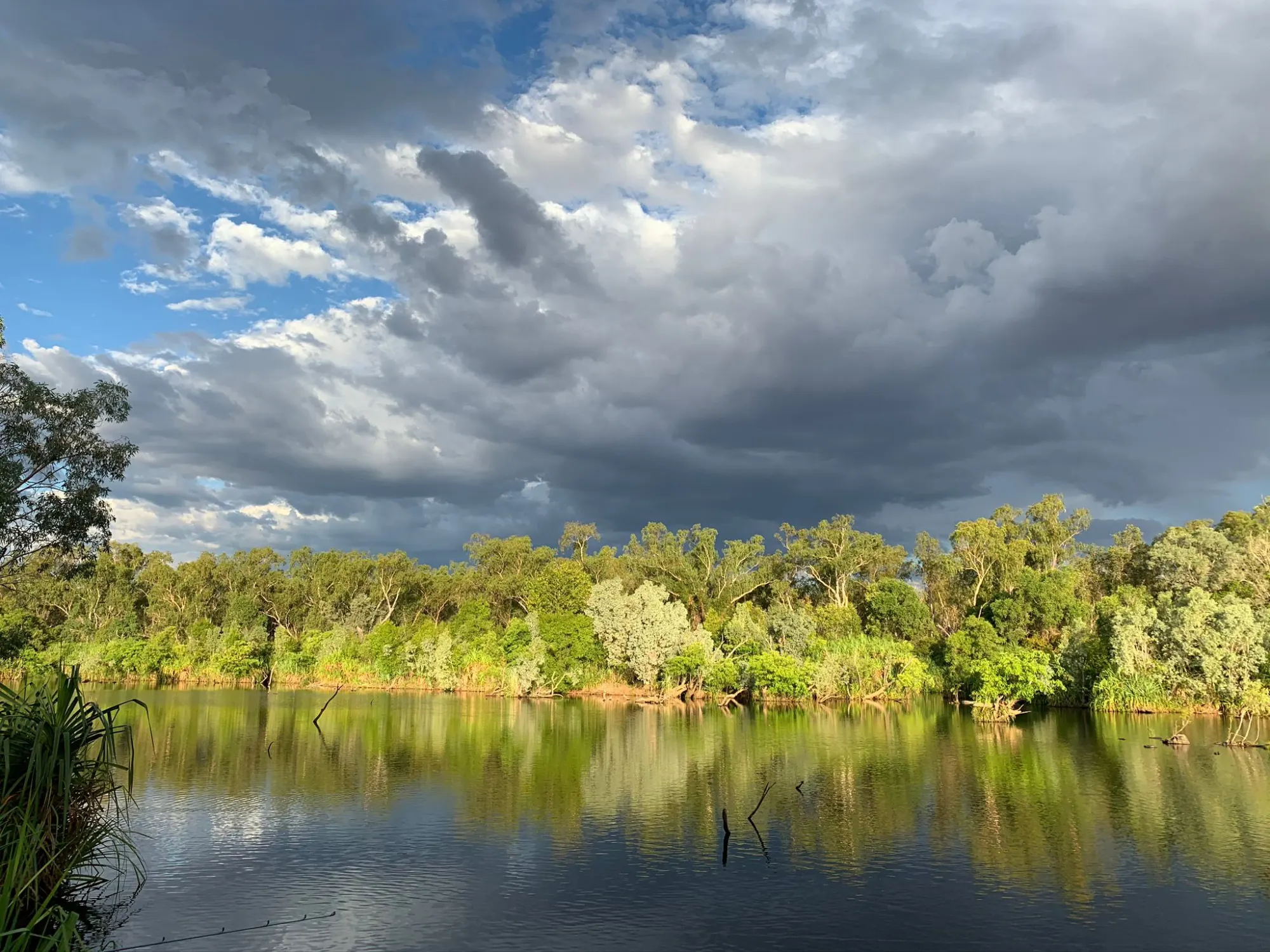 River billabong under a brewing storm