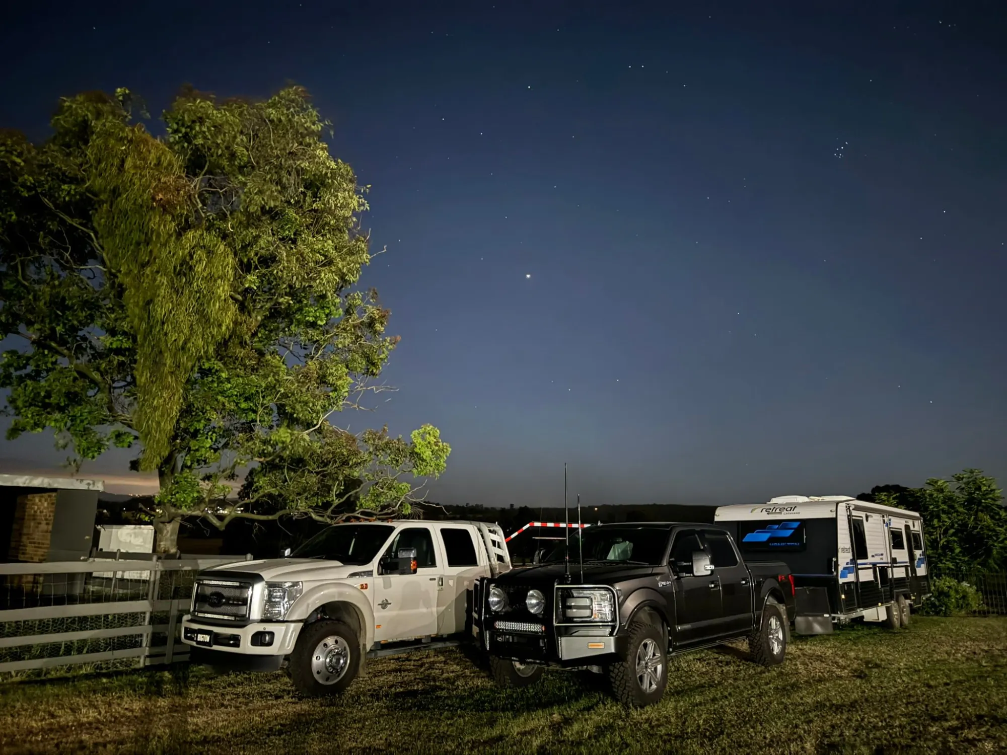 Working trucks and rig parked at the property at night