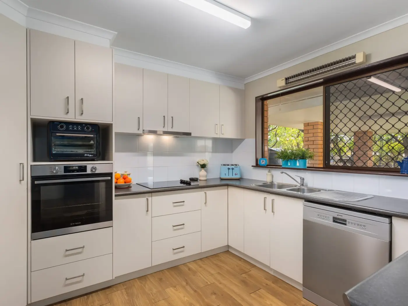 Kitchen with electric cooktop, wall oven and dishwasher