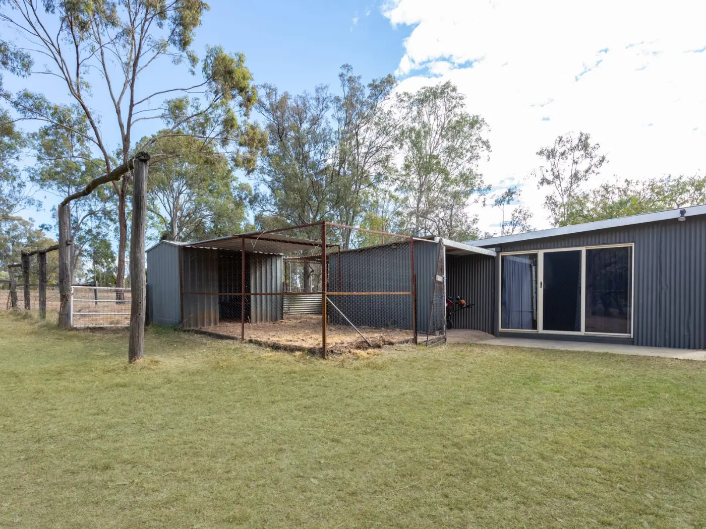 Detached shed with open bays and undercover parking